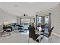 Open concept living room and dining room with tile floors, fan, modern furniture, and large windows at 4333 Bayside Village Dr # 110, Tampa, FL 33615