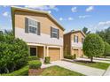 Charming townhome row with a one car garage, manicured landscaping, and neutral color palette at 4528 Winding River Way, Land O Lakes, FL 34639