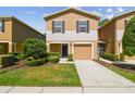 Charming townhome with a one car garage, manicured landscaping, and neutral color palette at 4528 Winding River Way, Land O Lakes, FL 34639
