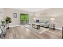 Comfortable living room with sliding doors to the balcony and modern neutral decor at 7208 S Juanita St, Tampa, FL 33616
