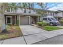 Desirable townhome with attached garage, driveway, and neutral exterior, showcasing its curb appeal at 8007 Bally Money Rd, Tampa, FL 33610