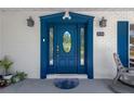 Close-up of a stylish blue front door with glass panels and decorative trim at 8314 Stillbrook Ave, Tampa, FL 33615