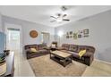 Cozy living room with tile floors, a ceiling fan, and comfortable seating arrangement at 842 Tennyson Mill Cir, Tampa, FL 33619
