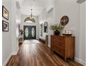 Spacious hallway with wood flooring, complemented by stylish decor and a view of the front entrance at 9084 Quail Creek Dr, Tampa, FL 33647