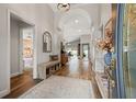 Inviting hallway with wood-look tile, arched ceilings, and views of the home's interior and backyard at 9084 Quail Creek Dr, Tampa, FL 33647