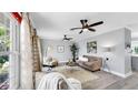 Bright living room features neutral tones, ceiling fans, and plenty of natural light at 916 Sago Palm Way, Apollo Beach, FL 33572