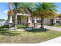 Attractive home with stone-accented pillars, enhanced by beautiful landscaping at 9931 Victory Gallop Loop, Ruskin, FL 33573
