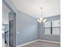 Dining area with a modern chandelier, neutral paint, and an outside view at 11006 Tahiti Isle Ln, Tampa, FL 33647