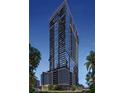 Modern high-rise building with glass exterior and multiple balconies, surrounded by lush green trees at 1101 E Jackson St # 2302, Tampa, FL 33602