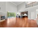Spacious living room featuring a fireplace, hardwood floors, and sliding glass doors to the outside at 1171 Red Maple Ne Cir, St Petersburg, FL 33703