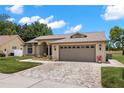 Inviting single-story home with a spacious two-car garage and beautifully landscaped front yard at 12339 Roseland Dr, New Port Richey, FL 34654