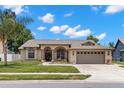 Charming single-story home with a well-maintained lawn, inviting entrance, and convenient two-car garage at 12339 Roseland Dr, New Port Richey, FL 34654