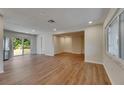 Spacious living room with new floors, neutral walls, and sliding glass doors to the yard at 12434 Cody Dr, Wimauma, FL 33598
