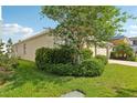 A well-landscaped yard and mature trees accent the exterior of this lovely home at 12830 Bent Twig Dr, Riverview, FL 33579