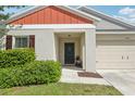 Welcoming front entrance with a charming wreath on the door and manicured landscaping at 12830 Bent Twig Dr, Riverview, FL 33579
