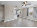Bright and spacious living room with modern flooring, ceiling fan, and an open layout to the kitchen at 1310 43Rd S St, St Petersburg, FL 33711