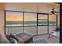 Enjoy spectacular ocean views from this private balcony, perfect for relaxation or entertaining with lounge chairs and a ceiling fan at 13720 Gulf Blvd # 302, Madeira Beach, FL 33708