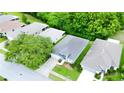 Aerial view of a lovely single-story home showcasing its landscaping and proximity to mature trees at 14116 Whitecap Ave, Hudson, FL 34667