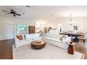Open-concept living area with stylish furnishings, hardwood floors, and abundant natural light throughout at 14902 Foxhound Pl, Tampa, FL 33624