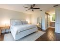 Serene bedroom with minimalist decor, wooden floors, and a walk-in closet at 14902 Foxhound Pl, Tampa, FL 33624