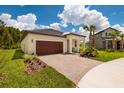 Charming home with a well maintained brick driveway and a beautifully landscaped yard, showcasing curb appeal at 17263 Mango Shay Ct, Land O Lakes, FL 34638