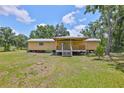 Charming one-story home featuring a covered front porch and well-maintained lawn, inviting outdoor relaxation at 2112 33Rd Se St, Ruskin, FL 33570