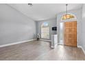 Bright living room featuring wood-look tile flooring and natural light at 2498 Saddlewood Ln, Palm Harbor, FL 34685