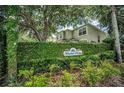 Meadow Ridge community sign surrounded by lush greenery and trees, providing a welcoming entrance to the neighborhood at 3002 Savannah Oaks Cir, Tarpon Springs, FL 34688