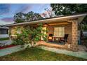 Inviting home exterior with a charming porch and comfortable seating, perfect for enjoying the outdoors at 314 Bath St, Tarpon Springs, FL 34689