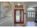 Inviting foyer showcasing a decorative glass front door and an elegant light fixture at 3338 Laurelwood Ct, Tarpon Springs, FL 34688