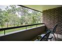 Relaxing balcony view with chairs overlooking lush green golf course and natural landscape at 36750 Us 19 N # 24-211, Palm Harbor, FL 34684