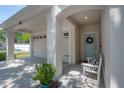 Inviting front porch with seating, covered entry and a view of the garage at 3906 N Lynn Ave, Tampa, FL 33603