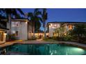 Beautiful backyard pool area with lush landscaping and soft lighting, perfect for evening relaxation at 405 S Shore Crest Dr, Tampa, FL 33609