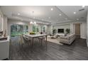 Bright living room features hardwood floors, ample natural light, modern decor, and a dining area at 4056 Southern Valley Loop, Brooksville, FL 34601