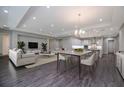 Spacious open-concept living room flowing to a modern kitchen with hardwood floors, modern furniture, and recessed lighting at 4056 Southern Valley Loop, Brooksville, FL 34601