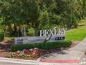 Bexley Club community sign surrounded by lush landscaping and colorful flowers at 4264 Bexley Village Dr, Land O Lakes, FL 34638