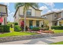 Charming home with landscaped front yard, inviting porch, and attractive curb appeal at 4264 Bexley Village Dr, Land O Lakes, FL 34638