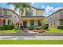 Inviting two-story home with a cozy front porch, beautiful landscaping, and a well-manicured lawn at 4264 Bexley Village Dr, Land O Lakes, FL 34638