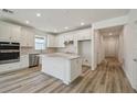 Bright kitchen featuring white cabinets, stainless steel appliances, and a center island at 4303 Big Sky Dr, Spring Hill, FL 34604