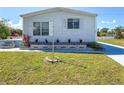 The home has a manicured lawn and a small brick garden, adding a touch of elegance at 4609 10Th Street E Ct, Ellenton, FL 34222