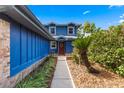 Charming blue home featuring a beautifully landscaped walkway leading to the front door at 5032 Cypress Trace Dr, Tampa, FL 33624