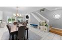 Bright living room features dining table and staircase at 5032 Cypress Trace Dr, Tampa, FL 33624