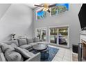 Cozy living room with large windows and sliding glass doors leading to the pool area at 5032 Cypress Trace Dr, Tampa, FL 33624