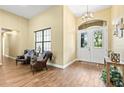 Inviting foyer with high ceilings, wood-look tile flooring, and decorative chandelier at 5319 W Trapnell Rd, Dover, FL 33527