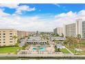 Community offers pool area and lounging area with chairs and umbrellas, and parking, all surrounded by green landscaping at 6020 S Shore Blvd # 709, Gulfport, FL 33707