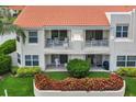 Backside of unit showcasing ground floor patio and second story balconies overlooking manicured landscaping at 6131 Bahia Del Mar Blvd # 241, St Petersburg, FL 33715