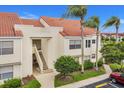 Exterior shot of building featuring stairs leading to units, complemented by manicured landscaping at 6131 Bahia Del Mar Blvd # 241, St Petersburg, FL 33715