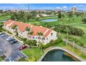 Exterior angle showcasing the property's well-kept landscaping, parking and views of the nearby golf course at 6131 Bahia Del Mar Blvd # 241, St Petersburg, FL 33715