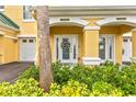 Charming front door with decorative wreath, glass accents, and vibrant, well-maintained landscaping at 6319 Sunset Bay Cir, Apollo Beach, FL 33572