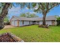 Single story home with an established lawn, rock bordered flower beds and a two-car garage at 6914 Harbor Dr, Hudson, FL 34667
